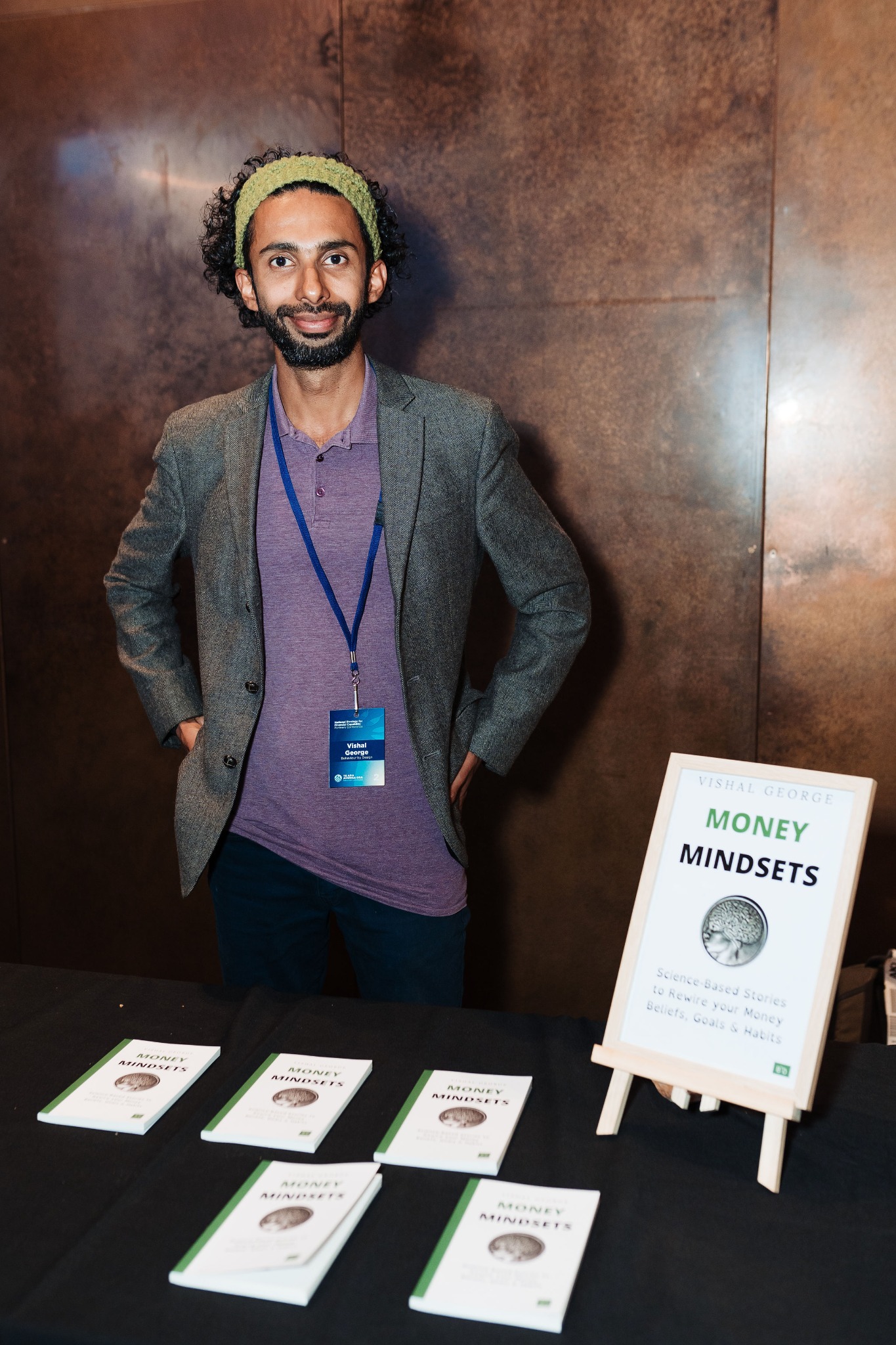 Vishal George standing beside a Money Mindsets book display.